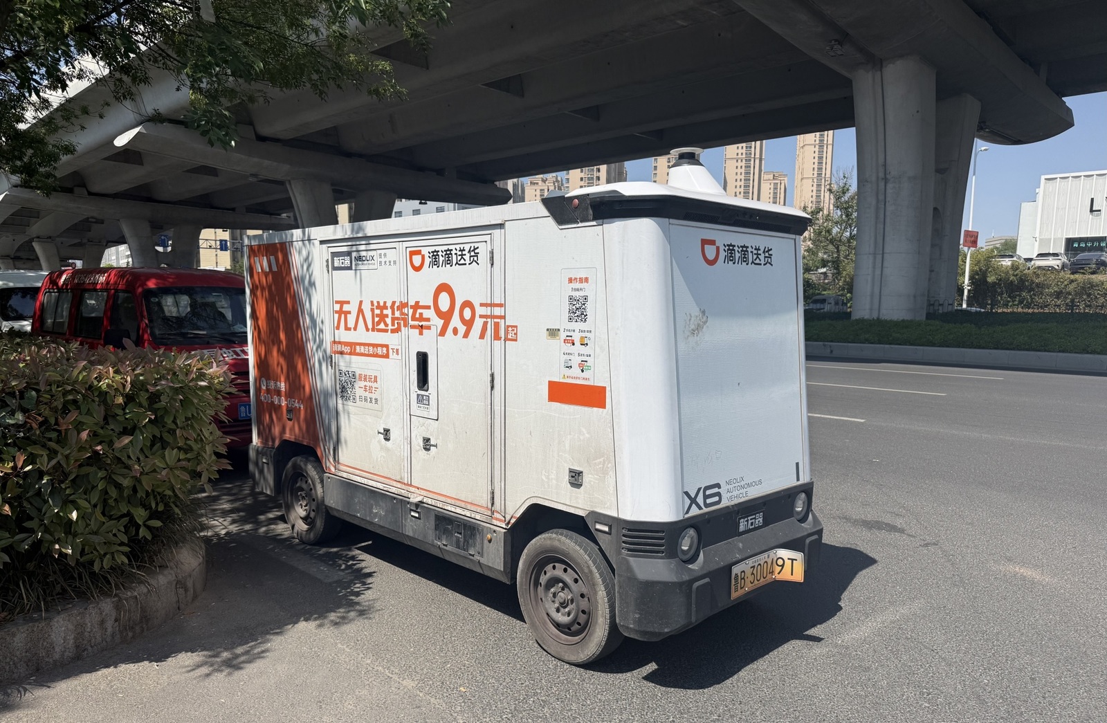 一线调研｜“9.9元跑30多公里”，青岛成无人车角力场：从低价抢客到基建卡位，新石器、九识、滴滴、货拉拉谁在抢跑？